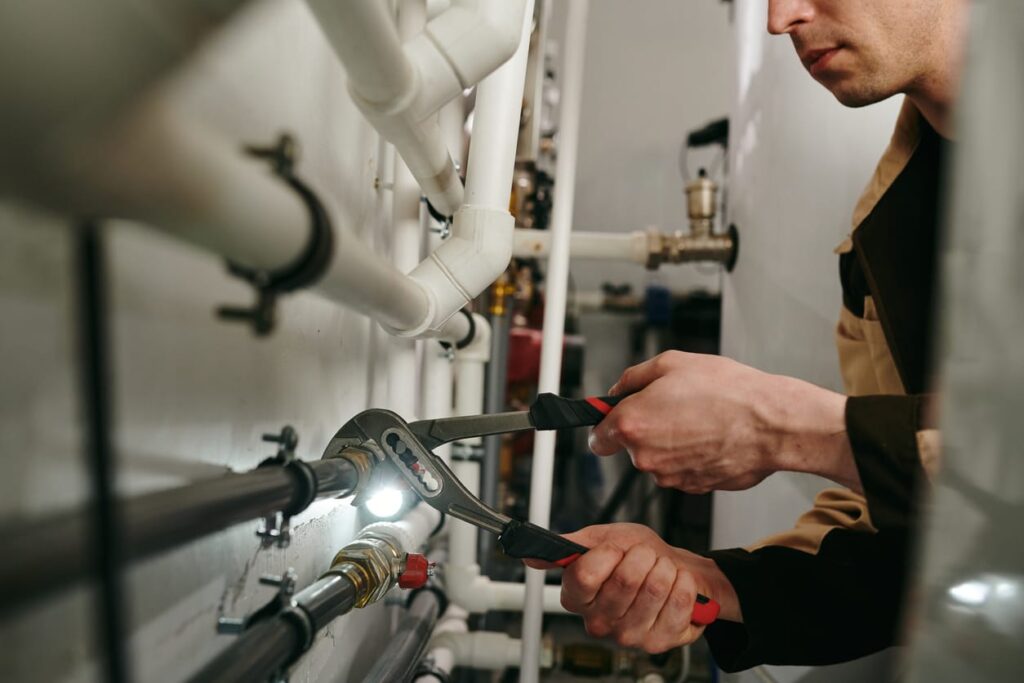 Plumbers maintaining commercial plumbing pipes in Banning