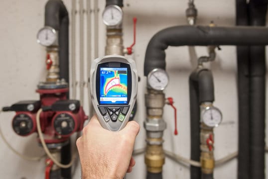 Plumber using a thermal imaging camera to inspect pipes in Banning