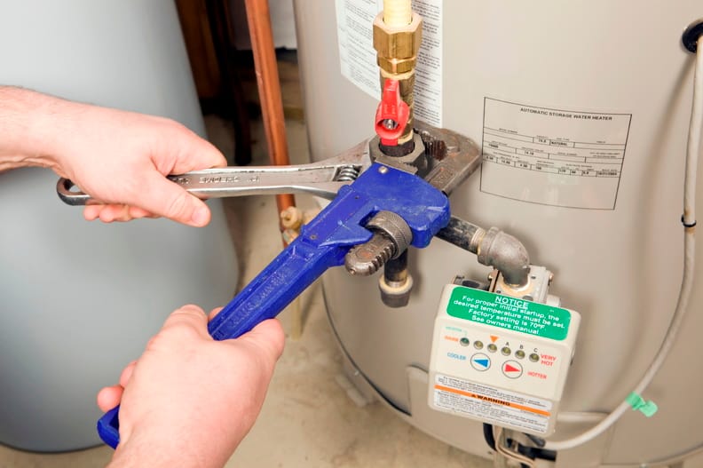 Plumber repairing a water heater valve in Banning